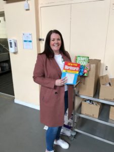 Gillian holds puzzle books donated to charity